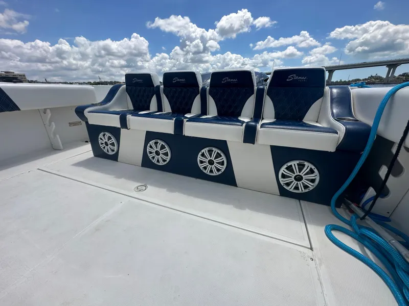 Slide: The Image of Stamas 290 Tarpon 2000 boat with blue and white seating and speakers on deck. - 11