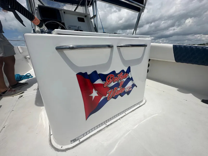 Slide: The Image of Stamas 290 Tarpon 2000 boat deck with Cuban flag and Dale Vieja text. - 12