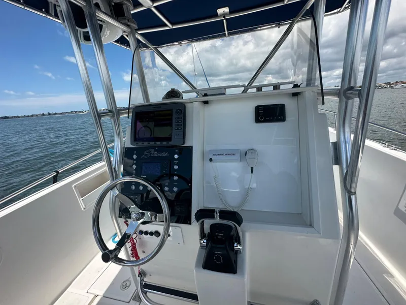 Slide: The Image of 2000 Stamas 290 Tarpon boat console with steering wheel and navigation equipment. - 18