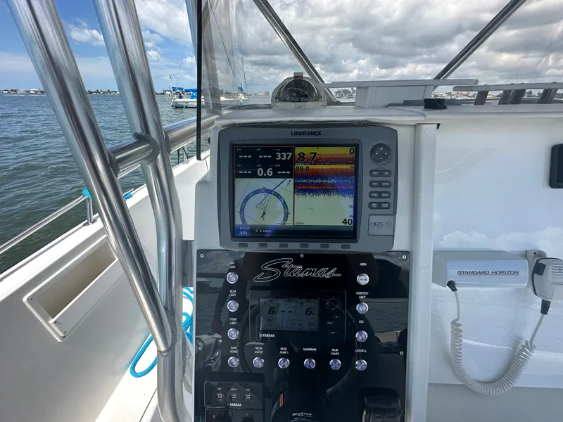 Slide: The Image of Control panel of a 2000 Stamas 290 Tarpon boat with navigation equipment. - 19