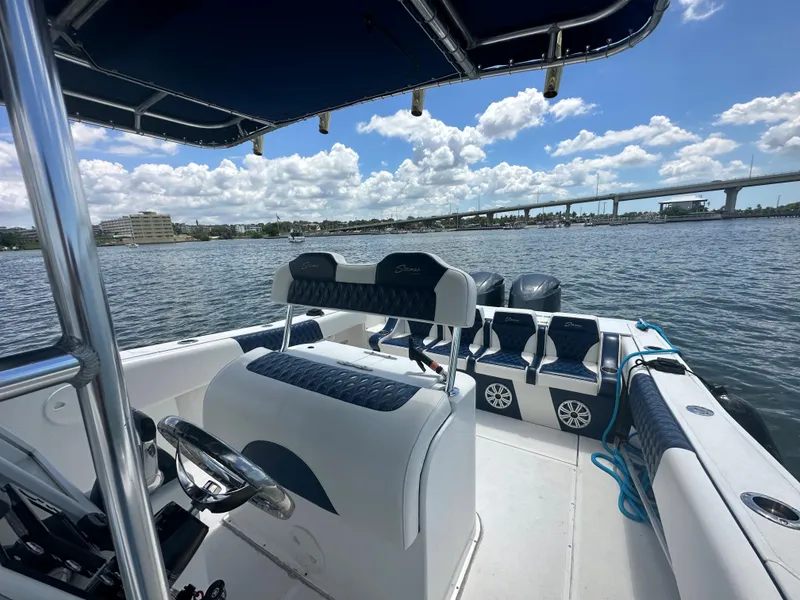 Slide: The Image of 2000 Stamas 290 Tarpon boat on water with bridge and cityscape in background. - 25