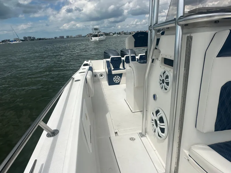 Slide: The Image of 2000 Stamas 290 Tarpon boat on water, featuring spacious deck and seating. - 28