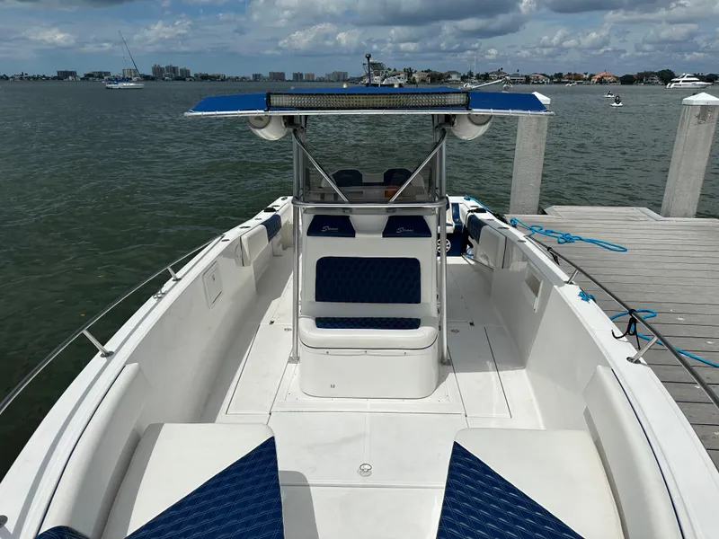 Slide: The Image of 2000 Stamas 290 Tarpon boat docked by the water on a sunny day. - 36