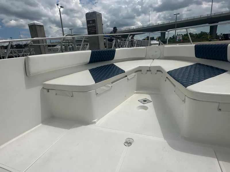 Slide: The Image of 2000 Stamas 290 Tarpon boat interior with cushioned seating and storage compartments. - 38