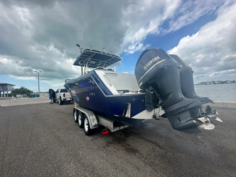 Slide: The Image of 2000 Stamas 290 Tarpon boat with Yamaha outboard engines on a trailer. - 45