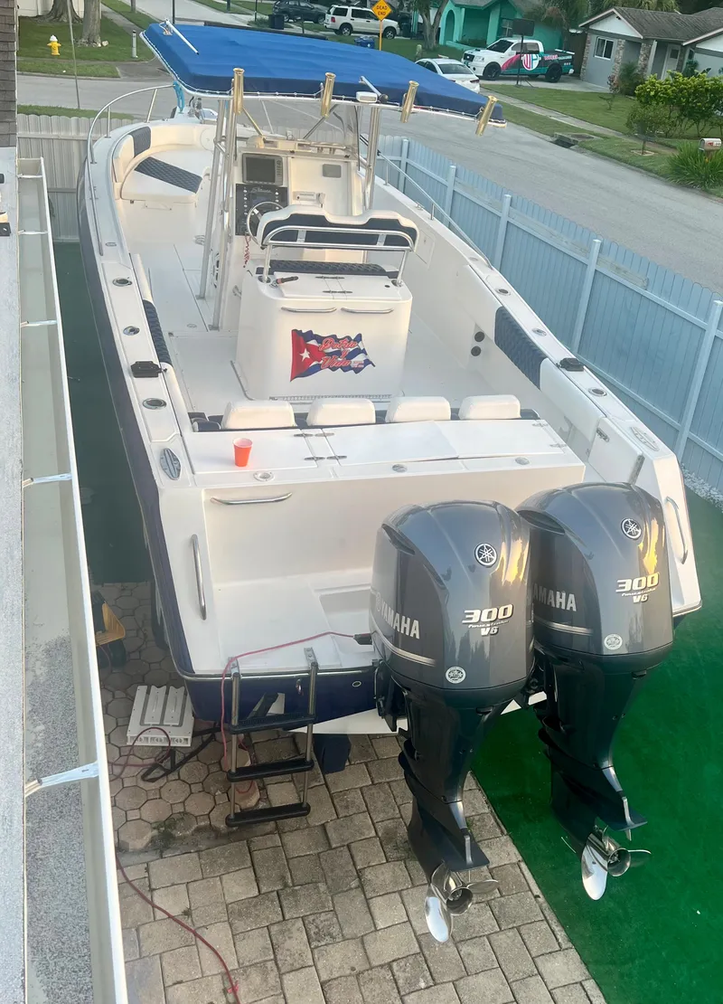 Slide: The Image of 2000 Stamas 290 Tarpon boat with twin Yamaha 300 engines docked in a residential area. - 46