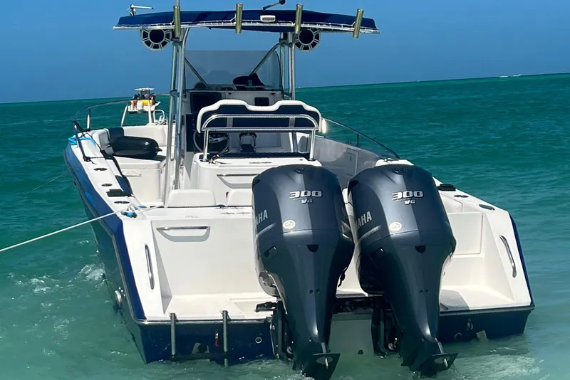 Slide: The Image of 2000 Stamas 290 Tarpon boat with twin Yamaha 300 engines in clear blue water. - 49