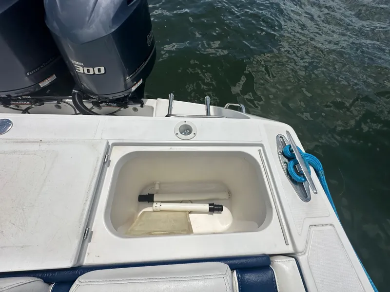 Slide: The Image of 2000 Stamas 290 Tarpon boat with open storage compartment and twin outboard engines. - 7