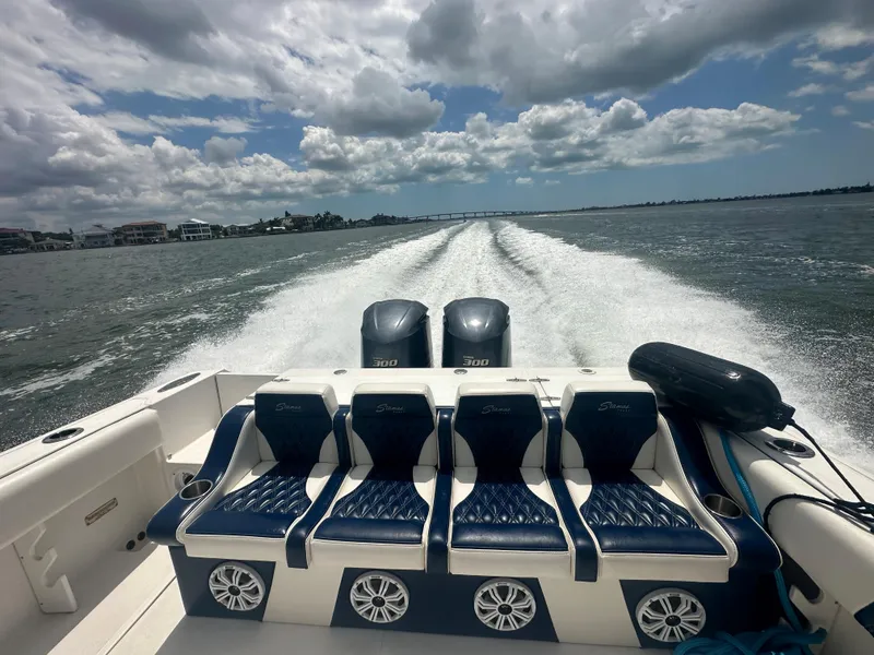 Slide: The Image of Stamas 290 Tarpon 2000 model boat cruising on open water with twin engines. - 8