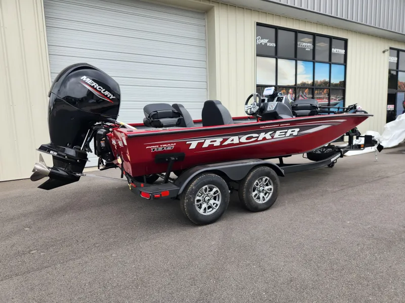 Slide: The Image of 2026 Tracker Pro Team 195 boat with Mercury engine, parked outside a dealership. - 2