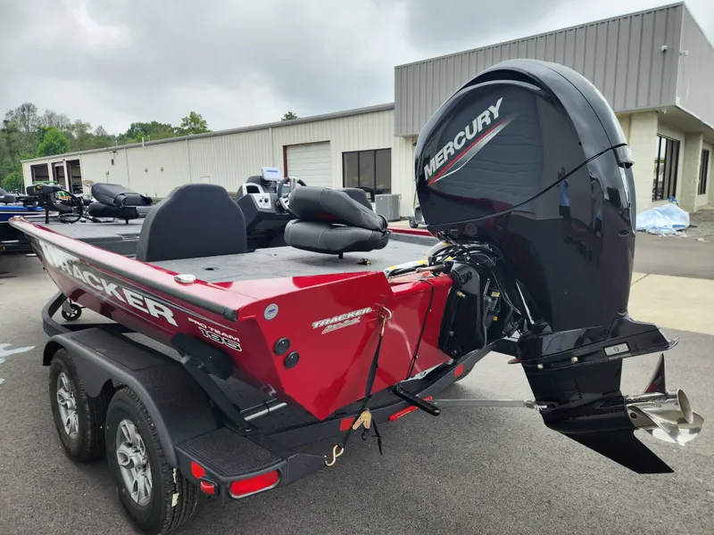 Slide: The Image of 2026 Tracker Pro Team 195 boat with Mercury engine, parked outside a building. - 4