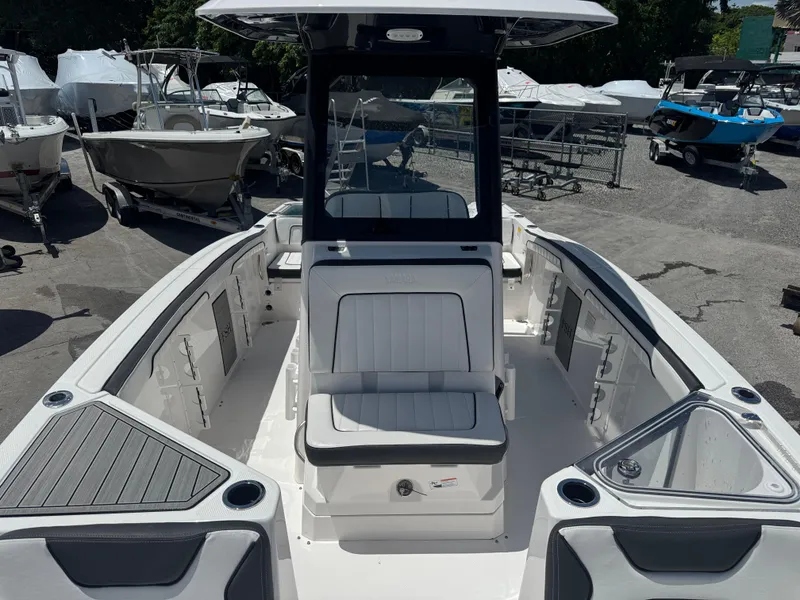 Slide: The Image of 2024 Yamaha Boats 255 FSH Sport E interior, showcasing seating and storage features. - 12