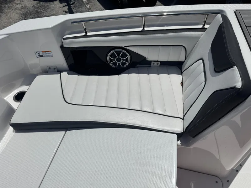Slide: The Image of 2024 Yamaha Boats 255 FSH Sport E interior seating with speaker and cup holder. - 14