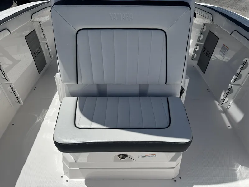 Slide: The Image of 2024 Yamaha Boats 255 FSH Sport E interior seating, featuring sleek white upholstery. - 15
