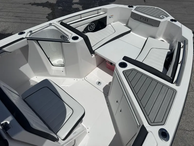 Slide: The Image of 2024 Yamaha Boats 255 FSH Sport E interior with seating and storage compartments. - 8