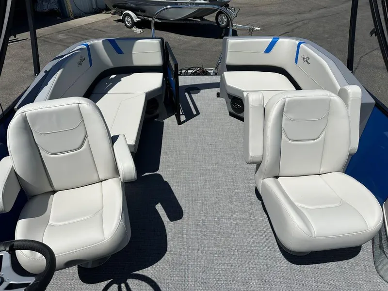 Slide: The Image of 2026 SunChaser Lucerne 20 LR DH pontoon boat interior with white seating and gray flooring. - 4
