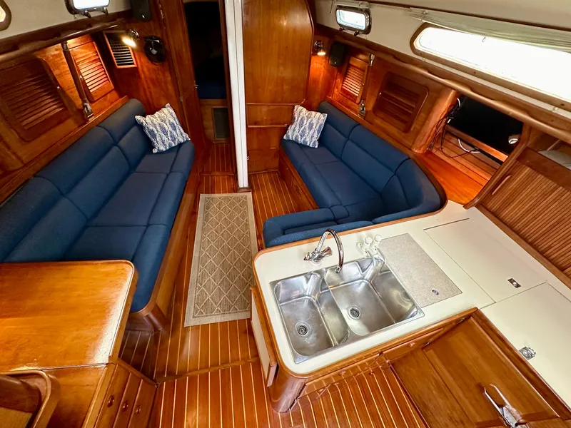 Slide: The Image of Interior of 1998 Sabre 362 yacht with blue seating, wooden finish, and dual sink. - 12