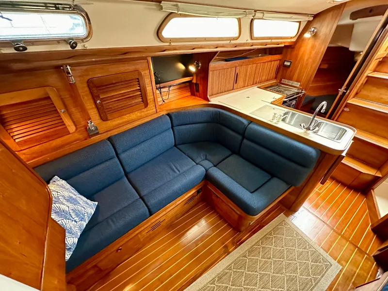 Slide: The Image of Interior of 1998 Sabre 362 yacht with blue seating, wooden finish, and kitchenette. - 14