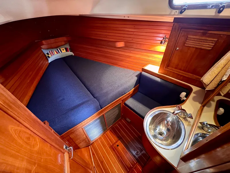 Slide: The Image of Cozy cabin interior of 1998 Sabre 362 sailboat with bed, sink, and wooden paneling. - 17