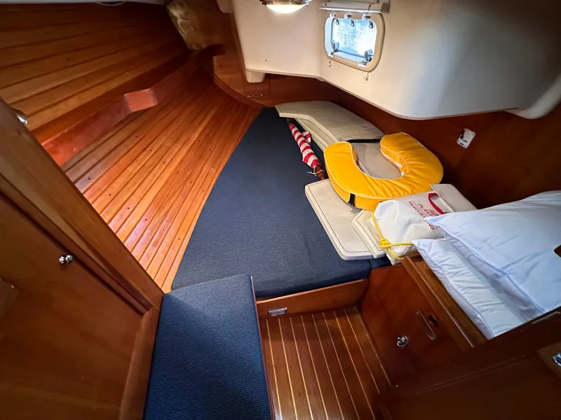 Slide: The Image of 1998 Sabre 362 cabin interior with wooden finish and cozy bedding. - 18