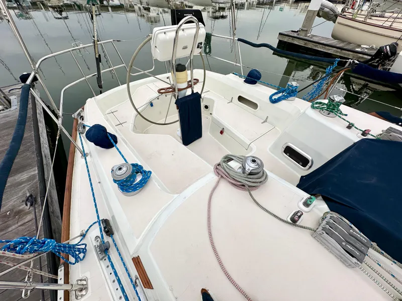 Slide: The Image of 1998 Sabre 362 sailboat cockpit with steering wheel and ropes, docked at marina. - 7