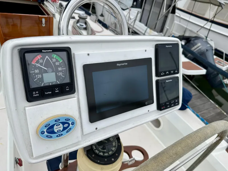 Slide: The Image of Cockpit navigation instruments on a 1998 Sabre 362 sailboat, featuring Raymarine displays. - 8