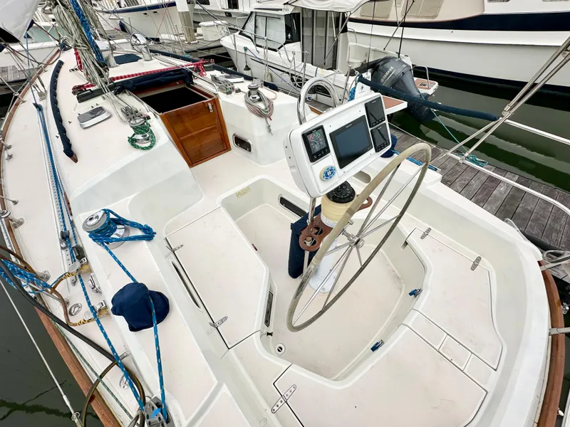 Slide: The Image of 1998 Sabre 362 sailboat cockpit with steering wheel and navigation equipment at marina. - 9