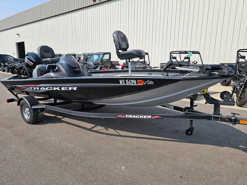 Slide: The Image of 2023 Tracker Pro Team 175 TXW fishing boat on trailer, parked outdoors. - 2