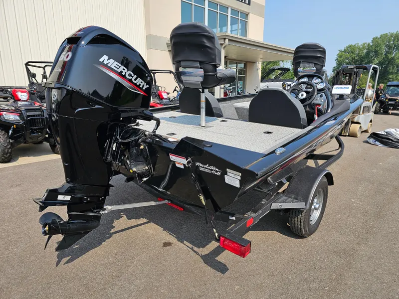 Slide: The Image of 2023 Tracker Pro Team 175 TXW boat with Mercury engine, parked outdoors. - 6