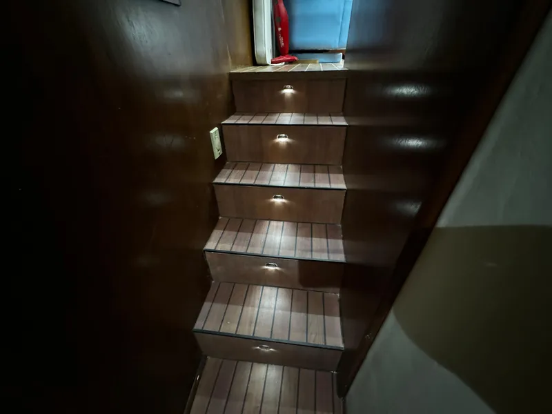 Slide: The Image of Wooden staircase with ambient lighting on a 1992 Ocean Yachts 48 Convertible. - 25