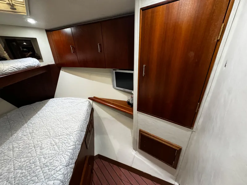 Slide: The Image of Interior cabin of 1992 Ocean Yachts 48 Convertible with wood cabinets and cozy bedding. - 31
