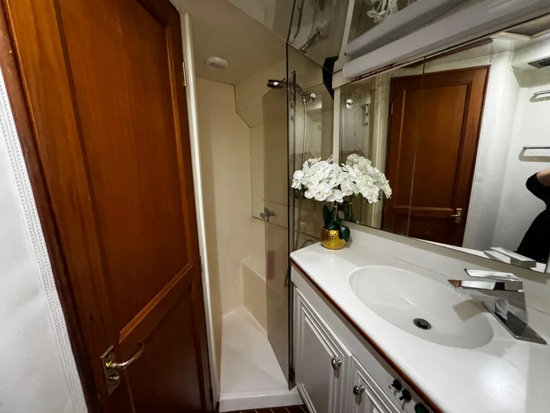 Slide: The Image of Luxurious bathroom in 1992 Ocean Yachts 48 Convertible, featuring elegant sink and shower. - 9
