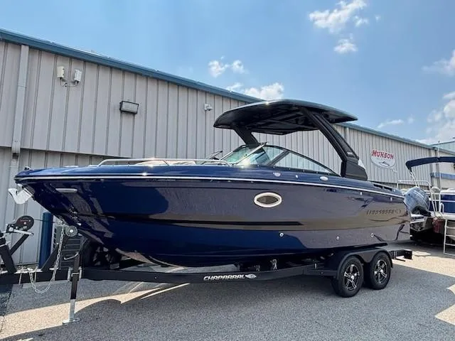 Slide: The Image of 2026 Chaparral SSX 6 boat on trailer, parked outdoors under a clear sky. - 2