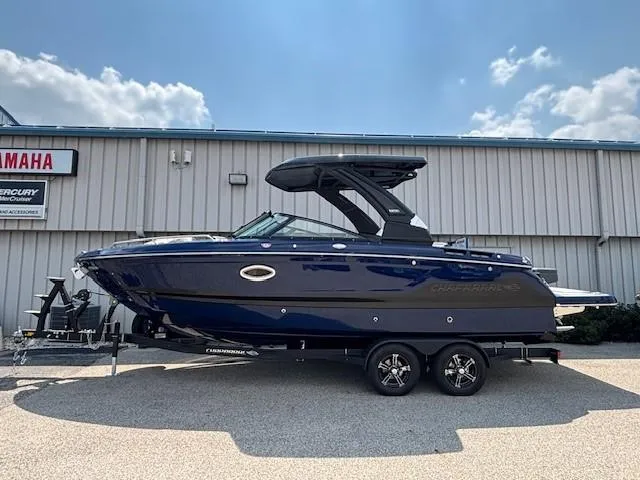 Slide: The Image of 2026 Chaparral SSX 6 boat on trailer, parked outdoors under a clear sky. - 24