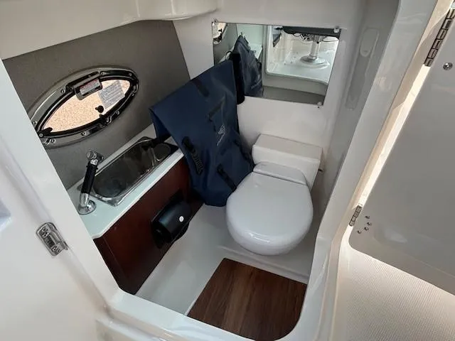 Slide: The Image of 2026 Chaparral SSX 6 boat bathroom with sink, toilet, and mirror. - 26
