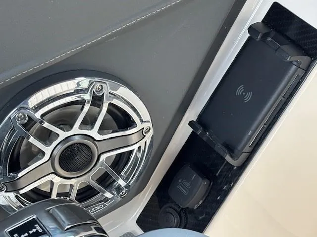Slide: The Image of Speaker and wireless charging pad on 2026 Chaparral SSX 6 boat dashboard. - 29