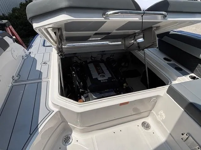 Slide: The Image of 2026 Chaparral SSX 6 boat engine compartment with open hatch, showcasing interior details. - 31
