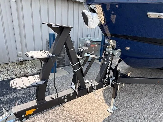 Slide: The Image of 2026 Chaparral SSX 6 boat on trailer, featuring a blue hull and sturdy support system. - 36