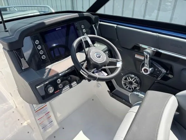 Slide: The Image of 2026 Chaparral SSX 6 boat dashboard with steering wheel and control panel. - 40