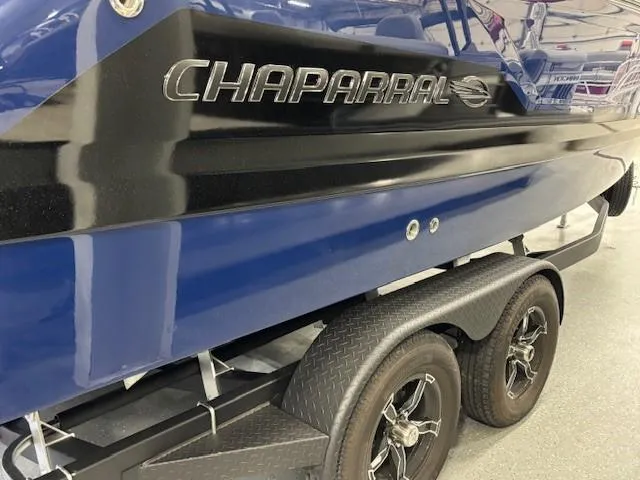 Slide: The Image of 2026 Chaparral SSX 6 boat on trailer, featuring sleek blue and black design. - 44