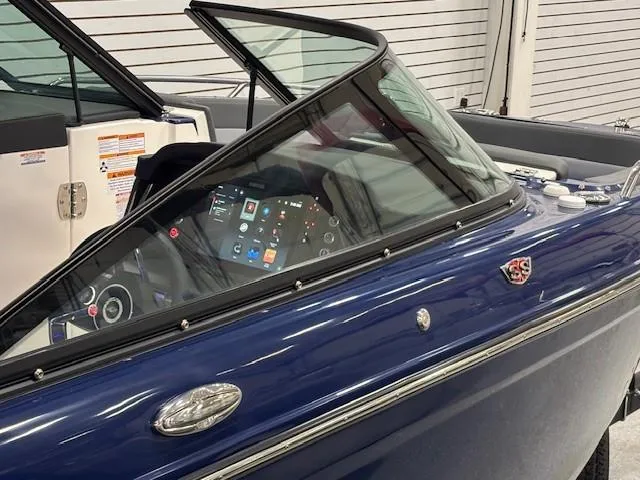 Slide: The Image of 2026 Chaparral SSX 6 boat with sleek blue design and modern dashboard. - 46