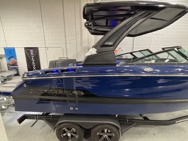 Slide: The Image of 2026 Chaparral SSX 6 boat in showroom, blue exterior, on trailer. - 47