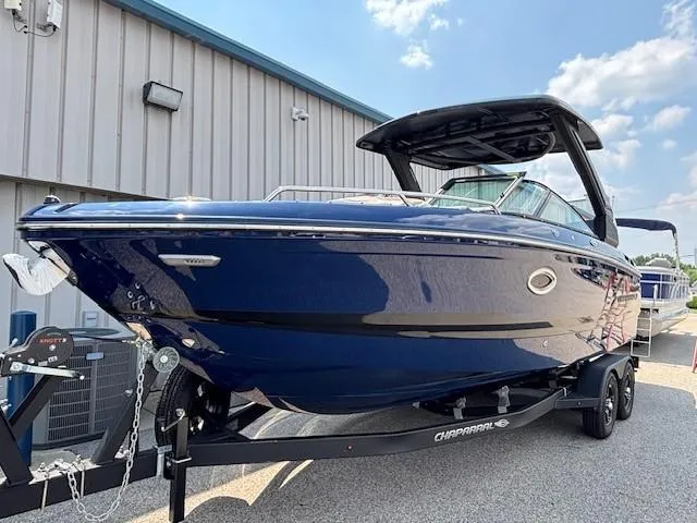 Slide: The Image of 2026 Chaparral SSX 6 boat on trailer, sleek blue design, parked outdoors. - 6