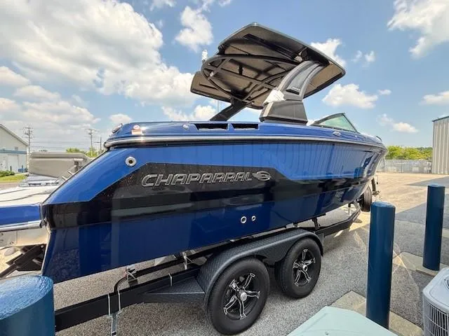Slide: The Image of 2026 Chaparral SSX 6 boat on trailer, blue exterior, sunny day. - 8