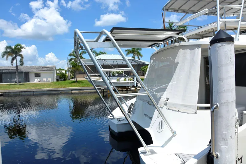 Slide: The Image of 2000 Fountaine Pajot Maryland 37 yacht docked by a serene waterfront. - 10