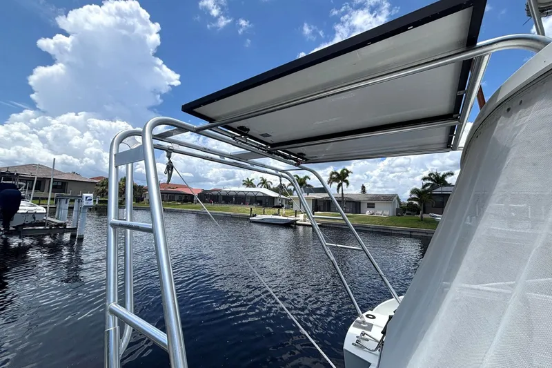 Slide: The Image of Fountaine Pajot Maryland 37 boat with solar panel, docked by waterfront homes, 2000 model. - 11