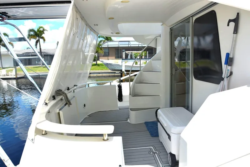 Slide: The Image of 2000 Fountaine Pajot Maryland 37 yacht deck with stairs and seating area. - 13