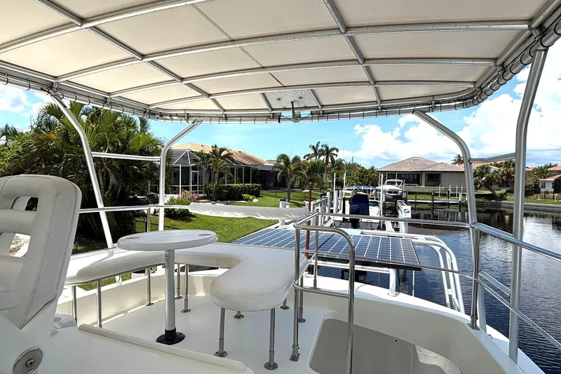 Slide: The Image of Flybridge view of 2000 Fountaine Pajot Maryland 37 yacht docked by waterfront homes. - 22