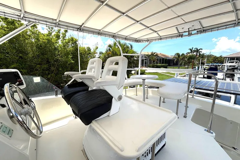 Slide: The Image of Flybridge of 2000 Fountaine Pajot Maryland 37 yacht with seating and steering wheel. - 23