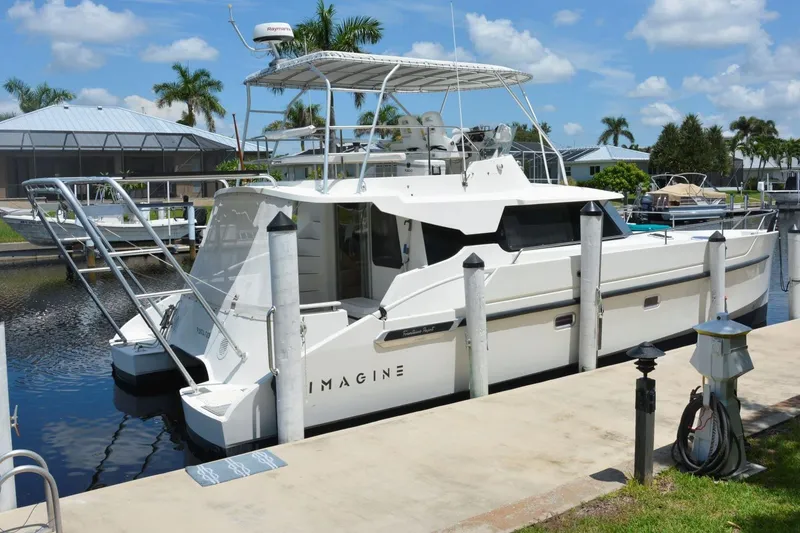 Slide: The Image of 2000 Fountaine Pajot Maryland 37 yacht docked in a sunny marina setting. - 3